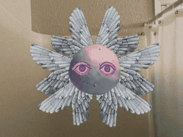 a drawing of a sun with wings and a face on it