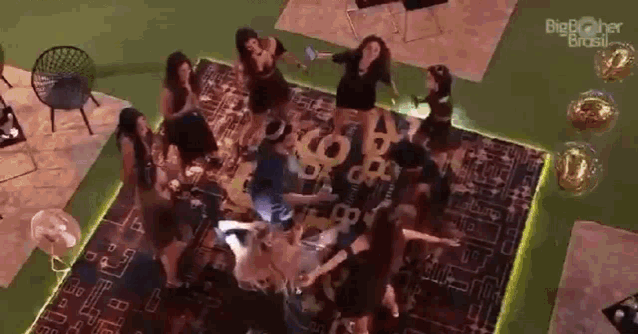 a group of people are dancing on a rug in a living room .
