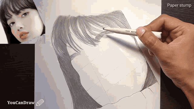 a person is drawing a woman 's face with a paper stump in the background