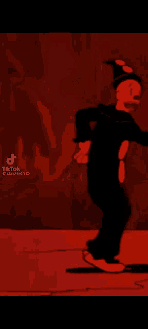 a cartoon character is dancing in a dark room with a red background