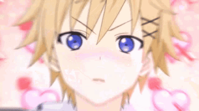 a boy with blonde hair and blue eyes with hearts around him