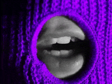 a woman 's mouth is visible through a hole in a purple scarf .