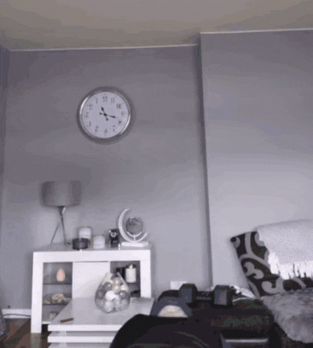 a living room with a clock on the wall that shows the time as 10:13