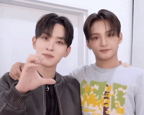 two young men posing for a picture with one wearing a shirt that says ' i love you '