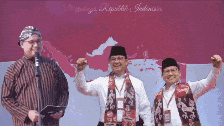 three men are standing in front of a flag with indonesia written on it