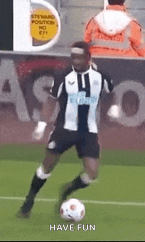 a soccer player is kicking a soccer ball on a field with the words have fun above him
