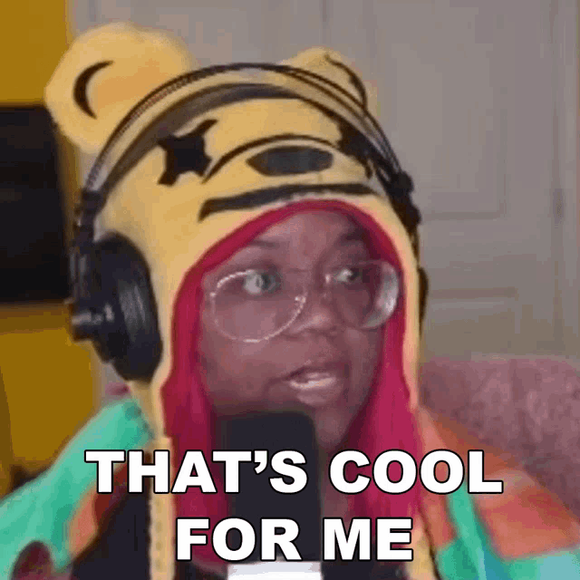 a woman wearing headphones and a winnie the pooh hat is talking into a microphone .