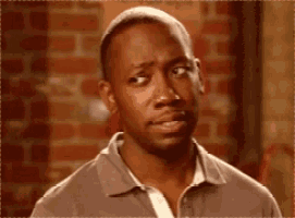 a man in a grey shirt is making a funny face .