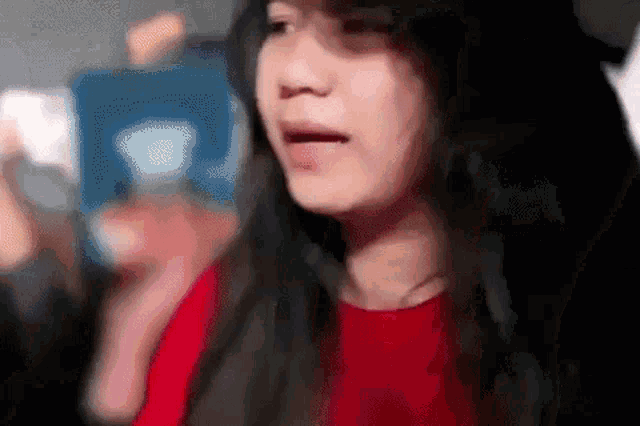a close up of a woman 's face with her tongue hanging out and a blurry background .