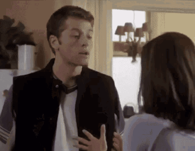 a man is talking to a woman in a living room .