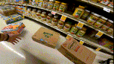 a person is reaching for a box that has the number 1 on it in a grocery store