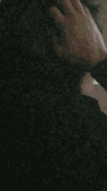 a close up of a person 's hand making a peace sign