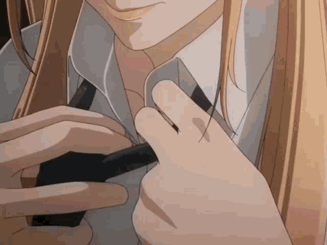 a close up of a person adjusting their shirt and tie
