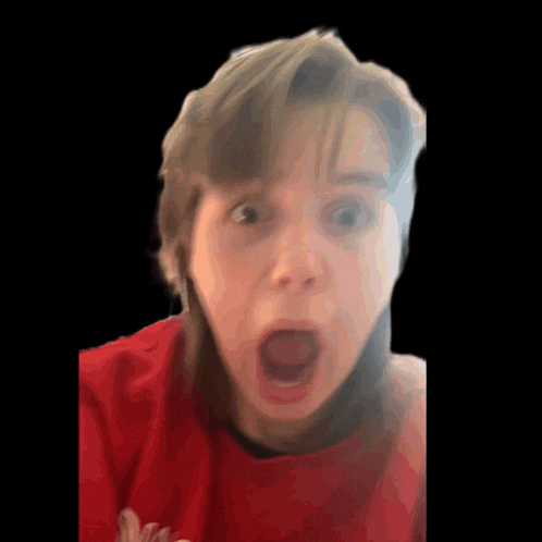 a woman in a red shirt is making a funny face with her mouth open