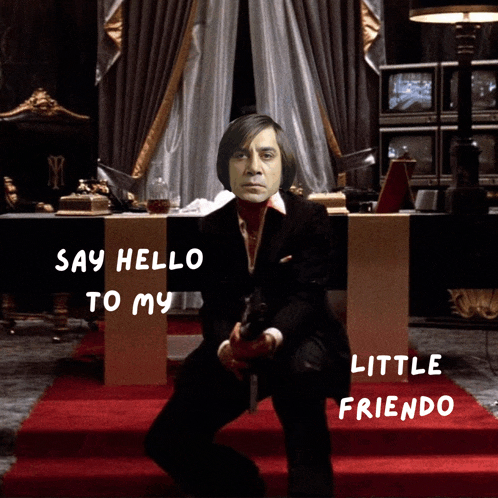a man in a suit holding a gun with the words say hello to my little friendo underneath him