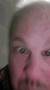 a close up of a person 's face with their eyes closed .