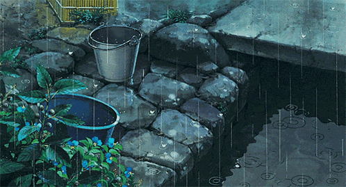 a bucket sits on a stone ledge next to a pond