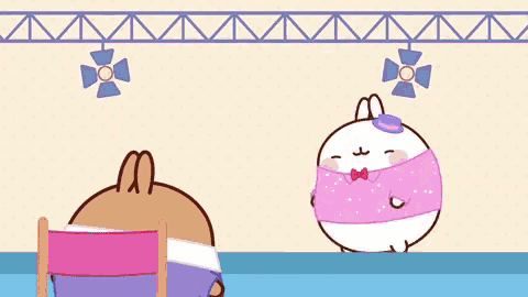 a cartoon rabbit is standing next to a chair and holding a pink shirt .