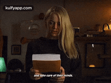 a woman is holding a book in her hands and saying " and take care of their minds "