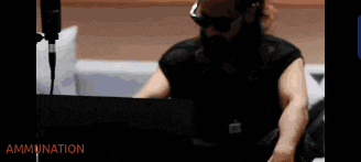 a man with a beard wearing headphones and glasses says " to preserve the artist 's creative work " in a video