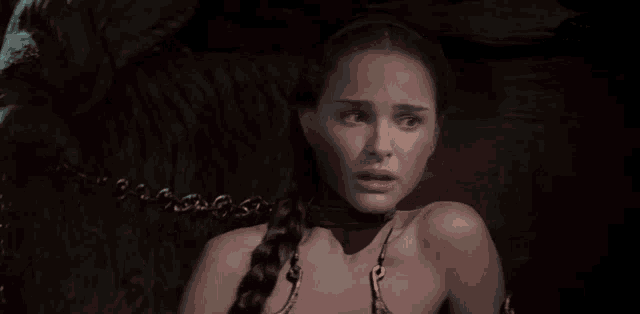 a woman in a braided ponytail is chained up
