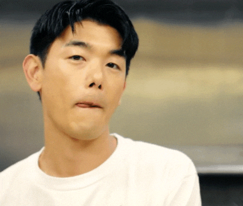 a close up of a man making a funny face with his tongue out
