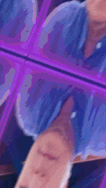 a blurry picture of a person 's face in a purple mirror