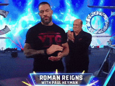 a wrestler named roman reigns with paul heyman standing on a stage