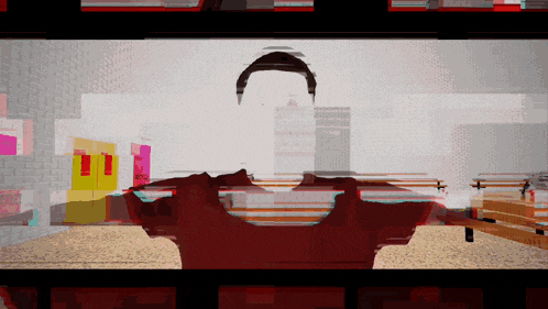 a man in a red shirt is in a room with a brick wall