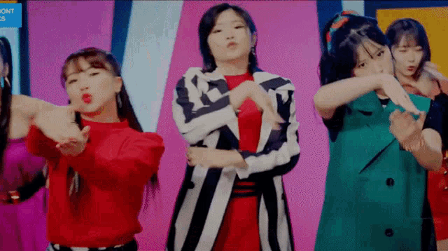 a group of young women are dancing in front of a sign that says ' dont touch '