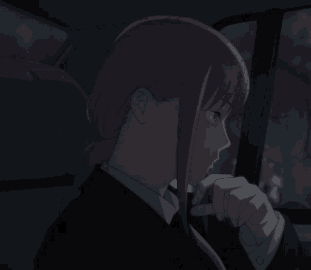 a woman with pink hair is sitting in a dark car