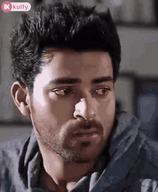 a close up of a man 's face with tears running down his cheeks .