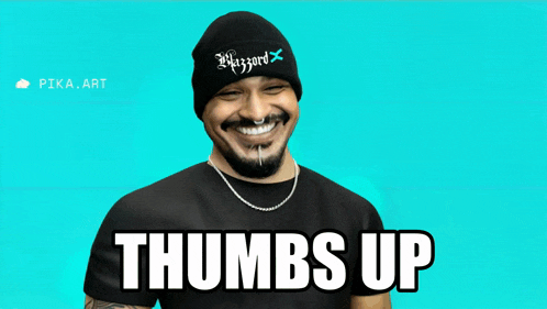 a man wearing a beanie and a t-shirt with the words thumbs up on it