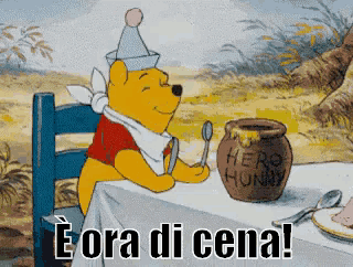 winnie the pooh sits at a table with a pot of honey