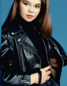 a woman wearing a black leather jacket and black turtleneck