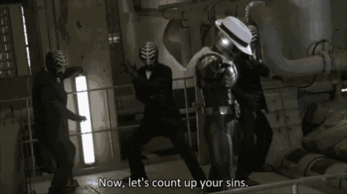 a person in a skeleton costume is pointing at the camera .