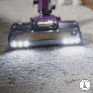 a purple vacuum cleaner is cleaning a carpet with the words sweed written on the corner