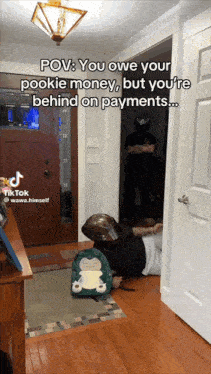 a man is laying on the floor in a hallway with the caption " pov : you owe your pookie money "
