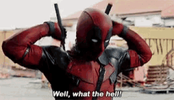 a man in a deadpool costume is holding a gun and saying well , what the hell .