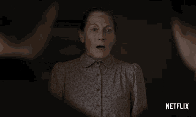 a woman with a surprised look on her face and a netflix logo behind her