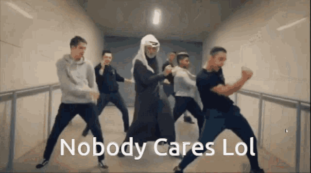 a group of men are dancing in a hallway with the words nobody cares lol written on the bottom