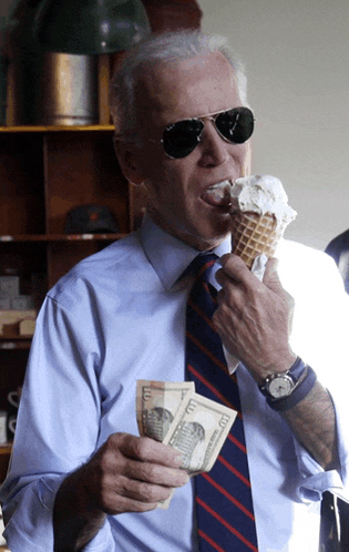 a man eating an ice cream cone while holding a pile of money