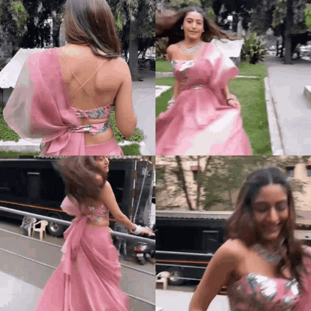 a woman in a pink dress is standing on a street