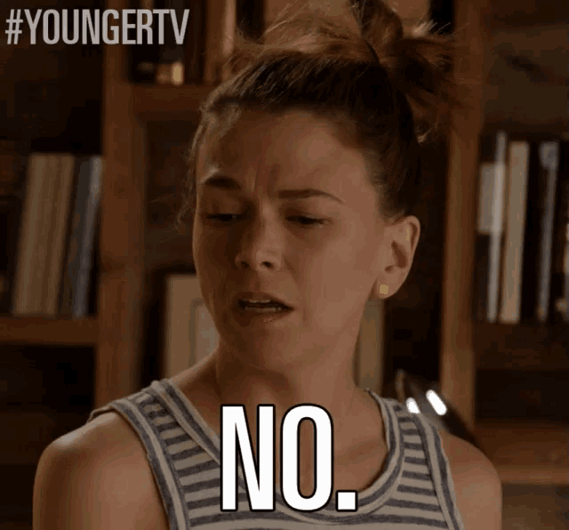 a woman in a striped tank top says no on her face