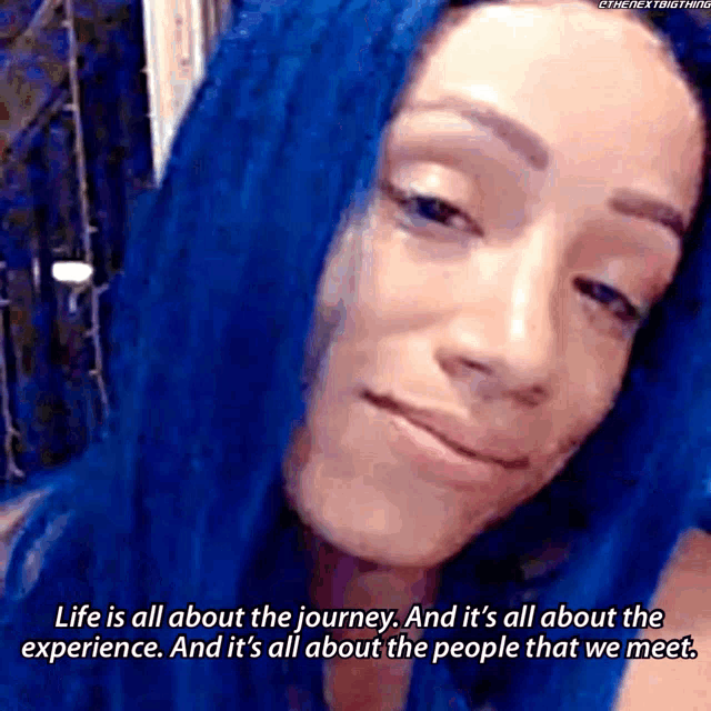 a woman with blue hair is smiling and says life is all about the journey and it 's all about the experience