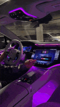 a person is driving a car with a red light on the dash