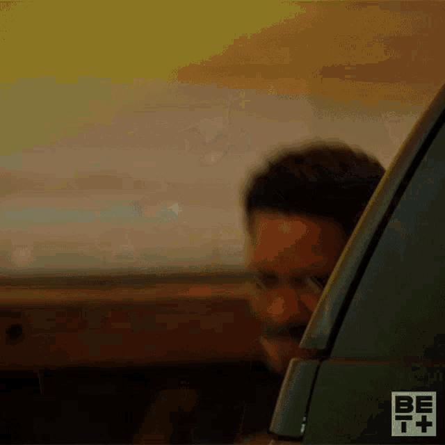 a man is holding a gun in front of his face and the word bet is on the bottom