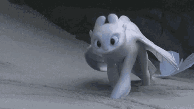 light fury from how to train your dragon is walking on the beach .
