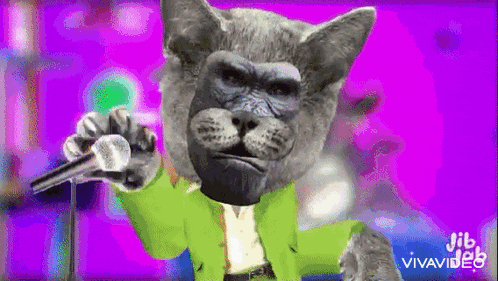 a cat with a gorilla face on it is singing into a microphone .