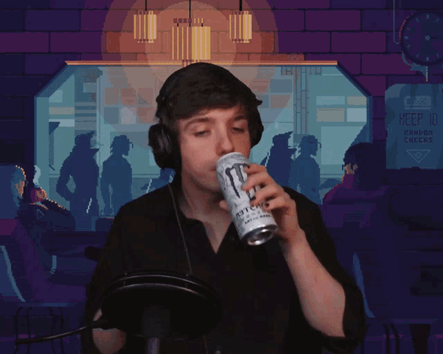 a man is drinking a monster energy drink